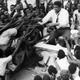 Nigerians swarm over Ali on in 1964 on his drive from Lagos Airport to his hotel atop a car.